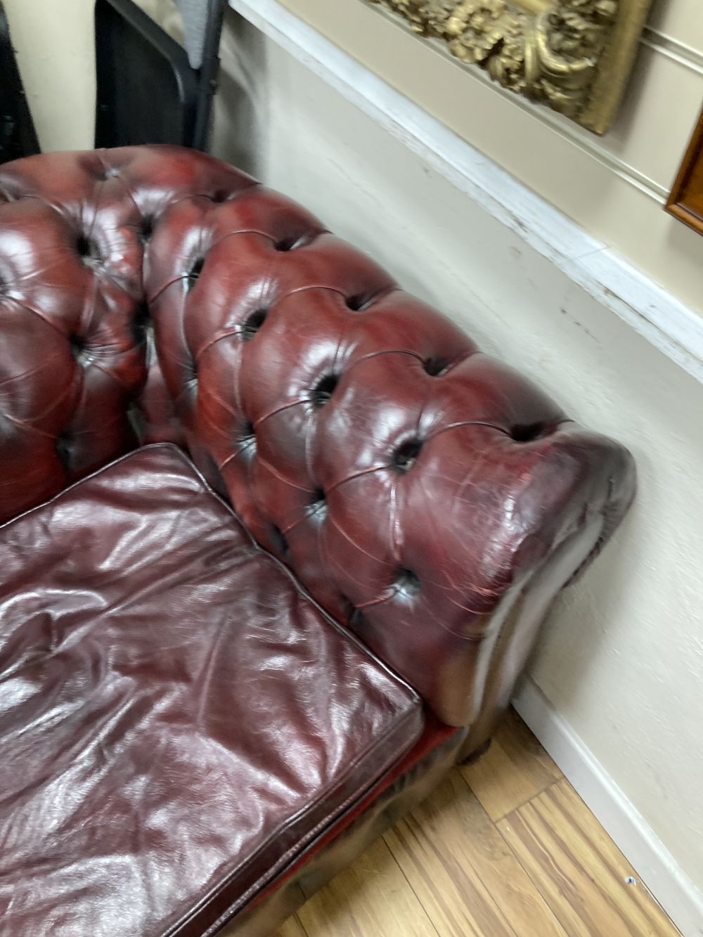A Victorian style buttoned burgundy leather three seater Chesterfield settee, width 190cm depth 85cm height 72cm